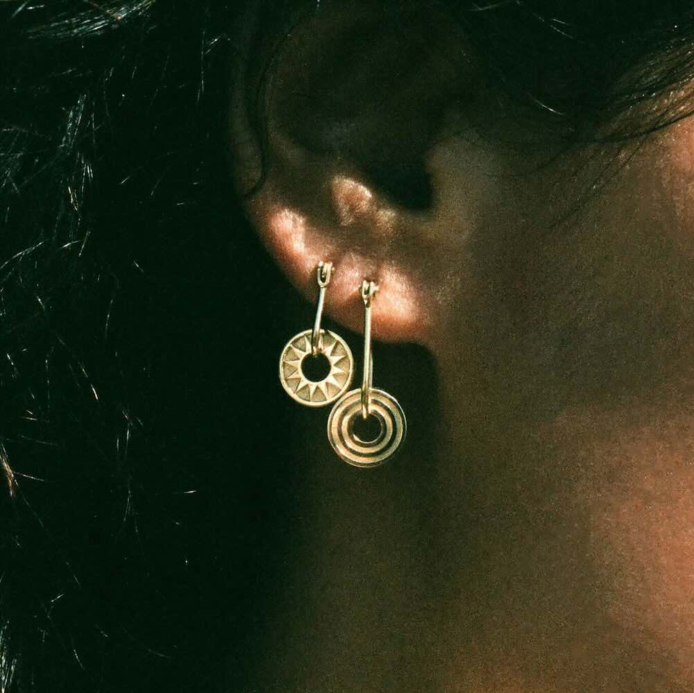 Model wearing Baby Cosmos Earring in yellow gold
