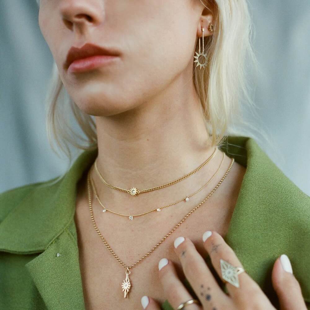 Model wearing Baby Spur Chain Necklace in yellow gold with white diamond