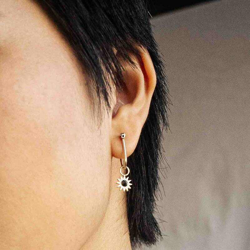 Model wearing Inverted Diamond Spur Earring in yellow gold with black diamond