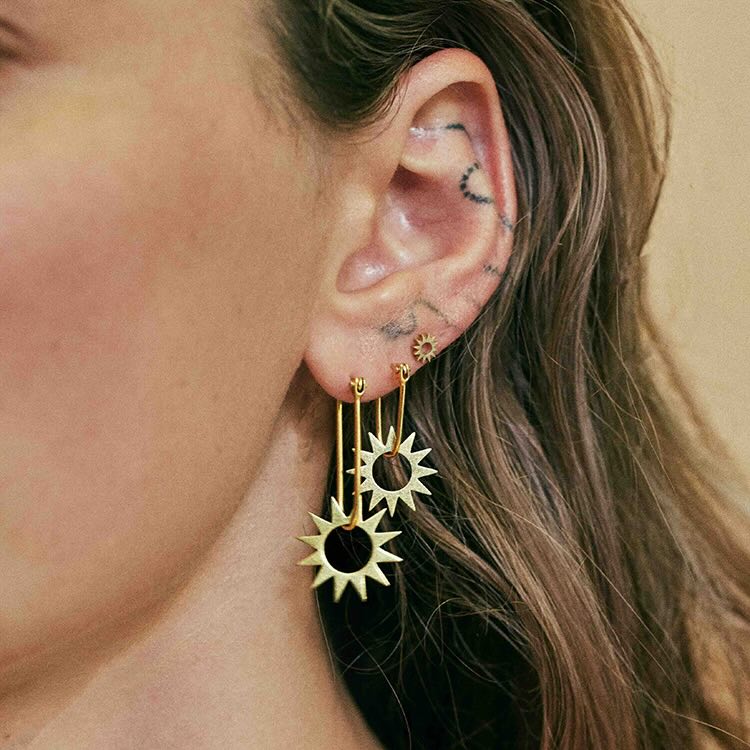 Model wearing Mini Spur Earring in yellow gold