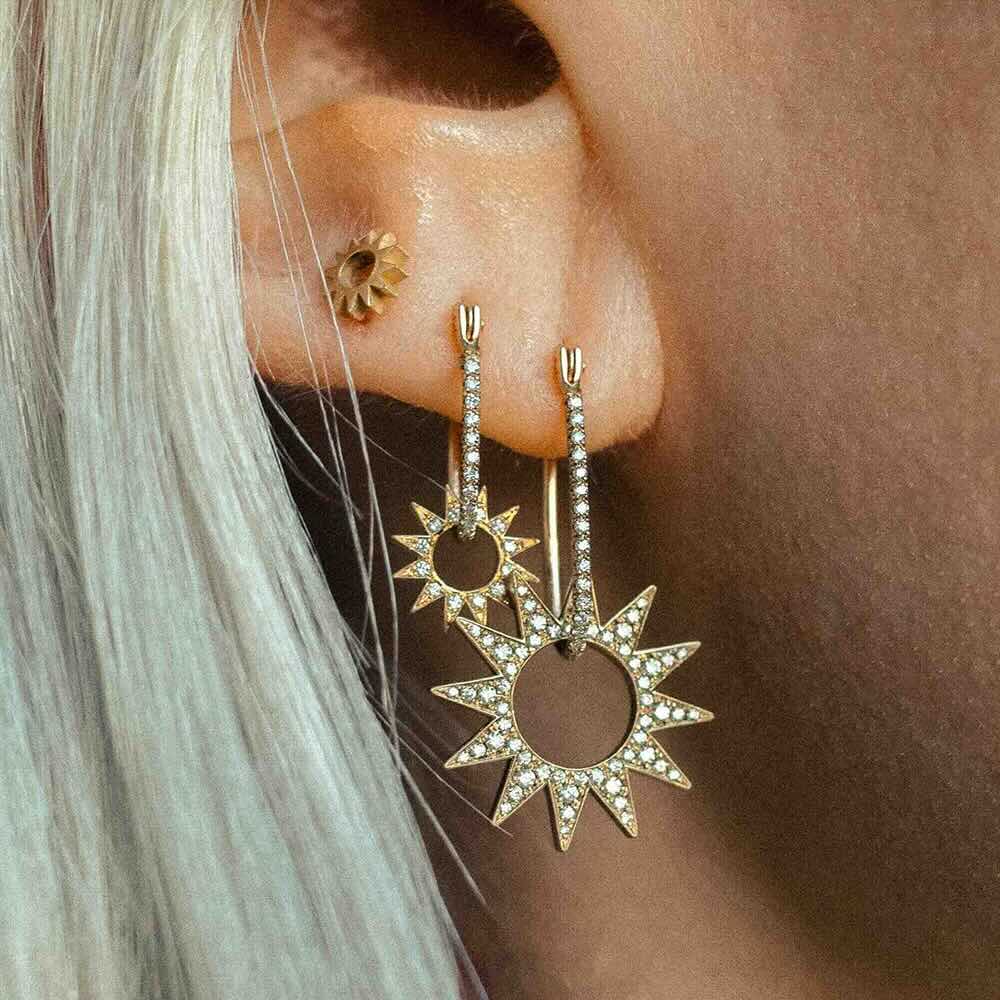 Model wearing Pavé Half Latch Earring in yellow gold with white pavé diamonds