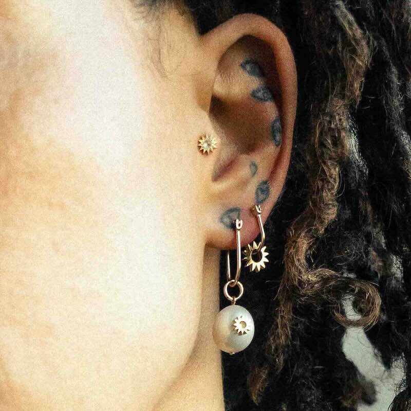 Model wearing Pearl Spur Earring in yellow gold