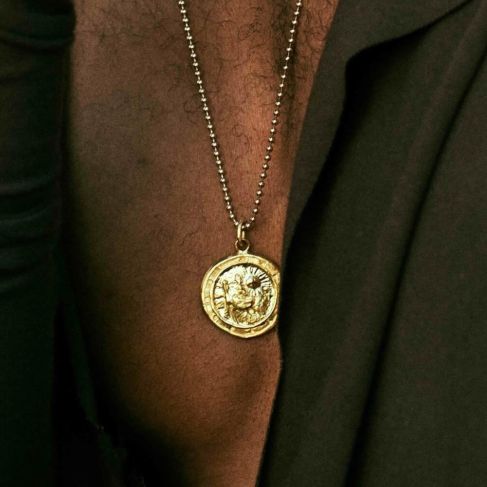 Model wearing Saint Christopher Pendant in yellow gold
