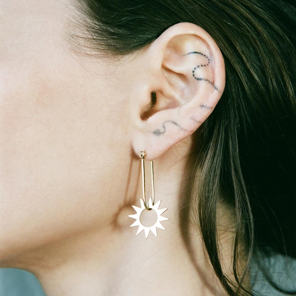 Model wearing Spur Earring in yellow gold